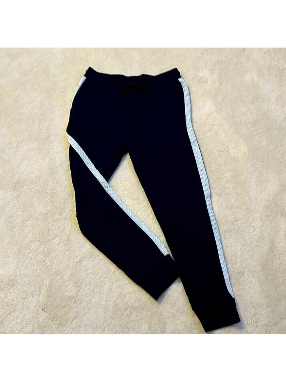 Black jogger with pearl edge accent along the outer seam